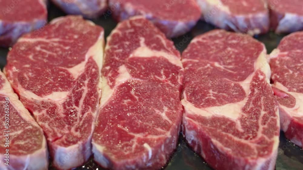 sliced pieces of raw meat to make fried steaks on baking tray. sliced pieces of raw meat to make fried steaks on baking tray.