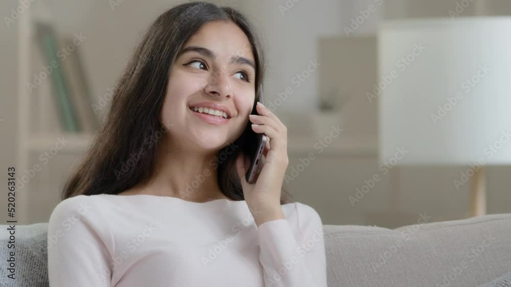Hispanic lady has mobile conversation friendly chatter at home cellular chatting talking with friend boyfriend arabic young girl woman flirting by telephone gadget gossiping share good positive news Hispanic lady has mobile conversation friendly chatter at home cellular chatting talking with friend boyfriend arabic young girl woman flirting by telephone gadget gossiping share good positive news