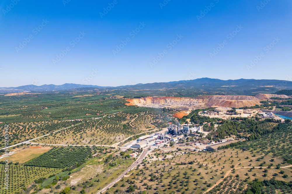 Drone shot during a beautiful day with clear blue sky of an open-mine in Greece. Human and nature concept. High quality photo