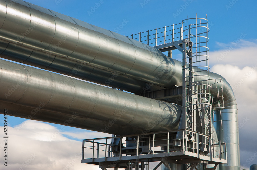 pipeline, in the photo pipeline close-up against a background of green forest and blue sky. pipeline, in the photo pipeline close-up against a background of green forest and blue sky.
