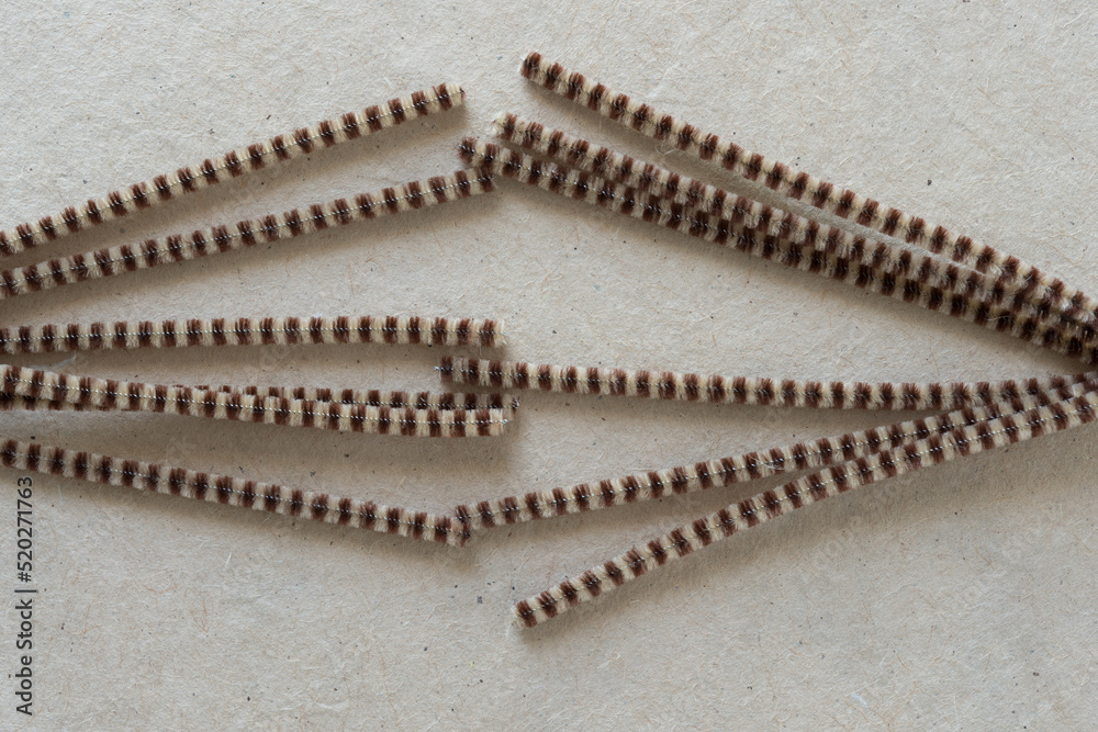 two sets of bent pipe cleaners on plain brown paper two sets of bent pipe cleaners on plain brown paper