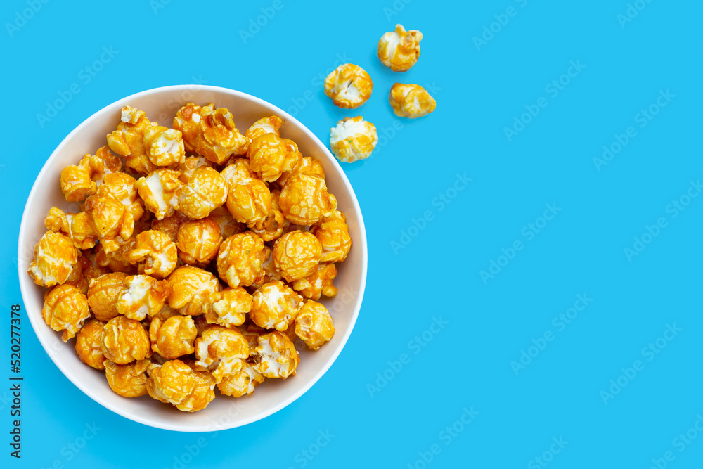 Honey caramel popcorn on blue background. Honey caramel popcorn on blue background.