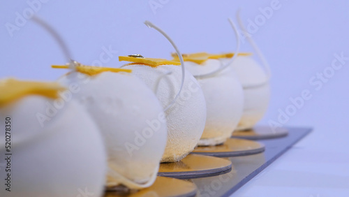 Velvet cake balls with sugar sprinkles. White  ball-shaped cakes. Decorative white cakes