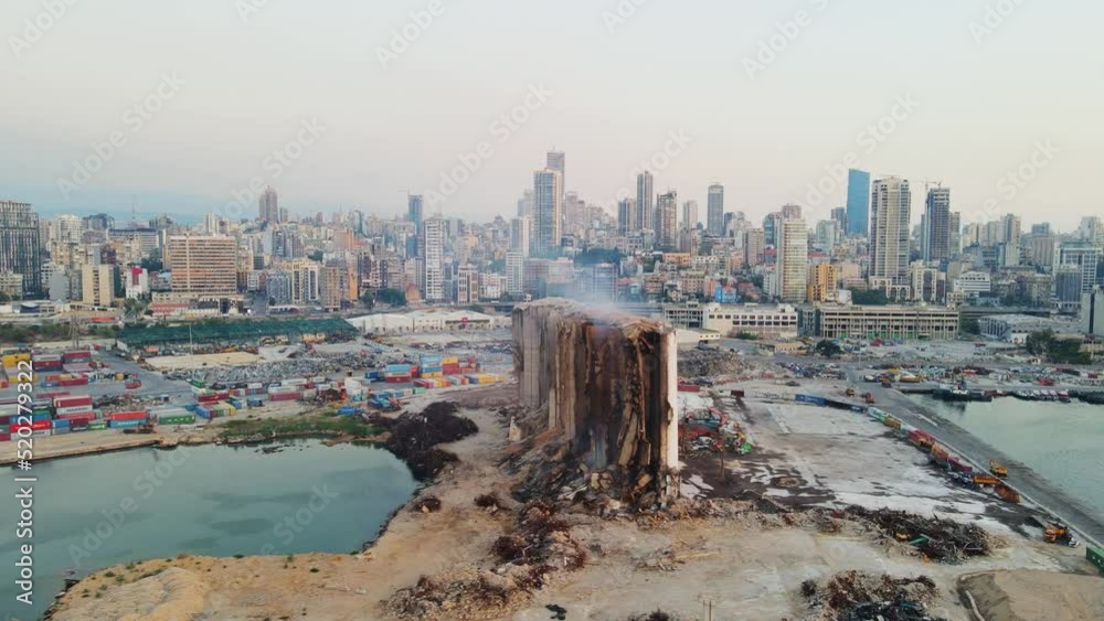 July 2022 - Drone Shots of Aftermath of the Beirut port explosion, featuring a damaged grain silo, twisted metal structures, and scattered debris amid ongoing reconstruction efforts.