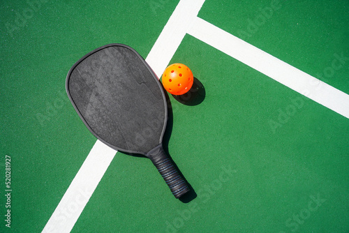 Slika na platnu Pickleball paddle and pickle ball on court.