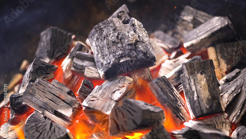 TView Of Hot Flaming Charcoal Briquettes Glowing In The BBQ Grill Pit. Burning Coals For Cooking Barbecue Food. Close Up
