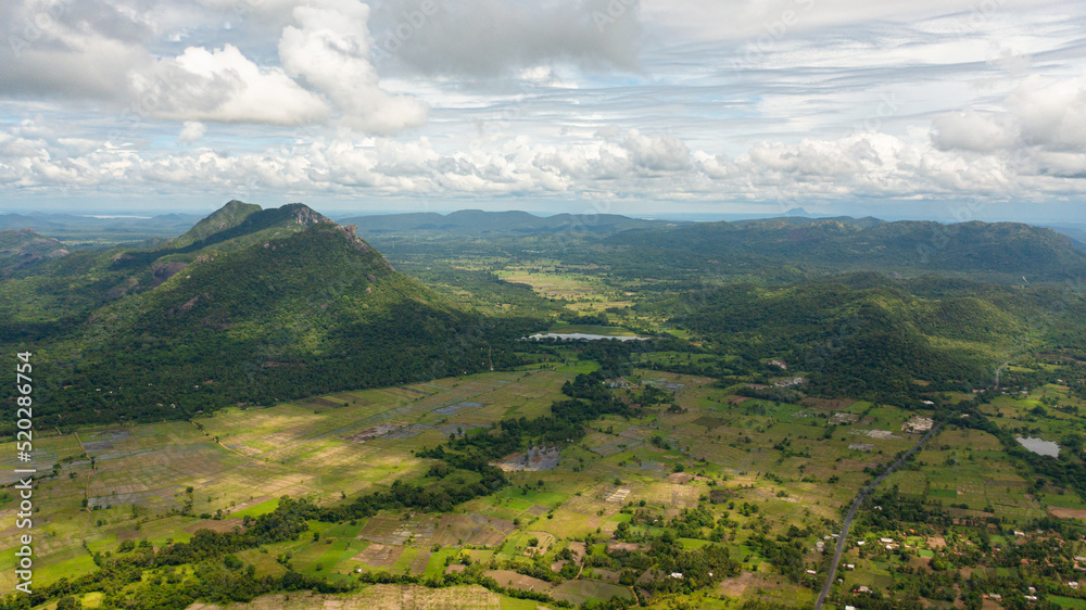 Mountain slopes with rainforest and a mountain valley with farmland. Sri Lanka