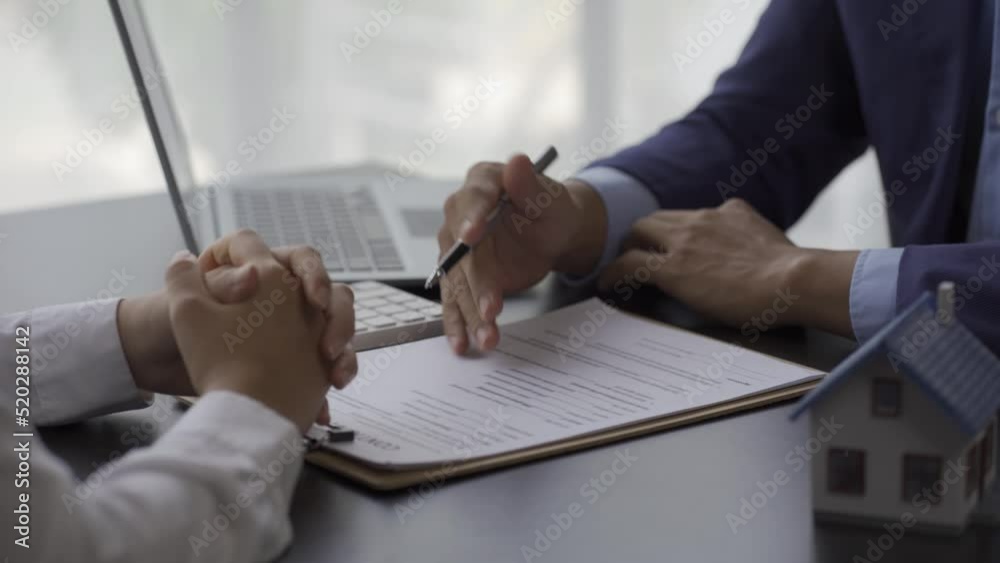 A sales representative shakes hands with a new homeowner's customer after the sale contract is complete. 4k real estate concept contract