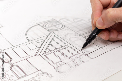 Making an architectural sketch with a pen. photo