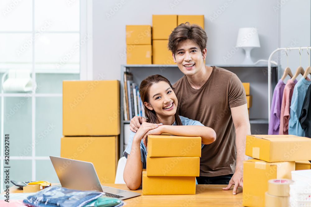 Young Asian couple business working in house office look like doing startup business and smiling happy and positive,Surprise of couple success on making big sale of his online store. Young Asian couple business working in house office look like doing startup business and smiling happy and positive,Surprise of couple success on making big sale of his online store.
