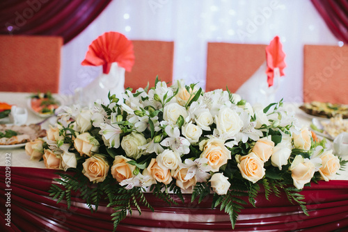 Bouquet of flowers in vase on the wedding table © tsezarina