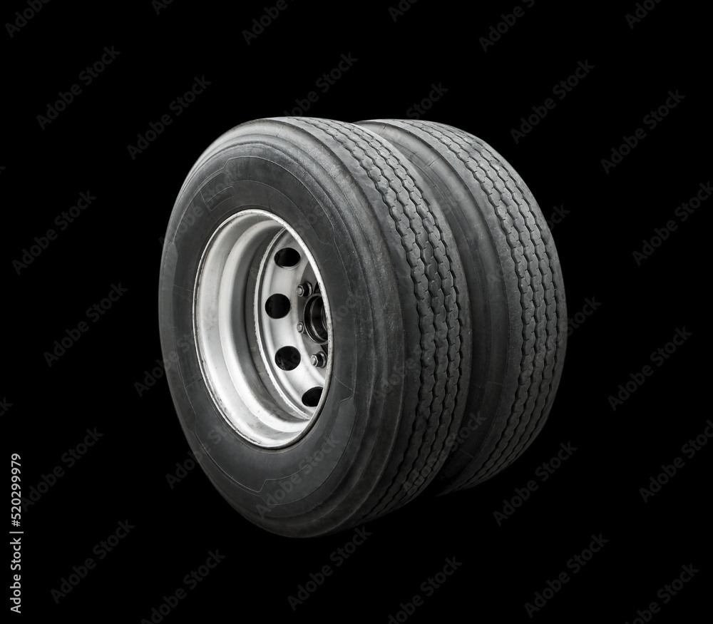 Fototapeta premium Big Semi Truck Wheels Tires Isolated on Black. Rubber, Truck Tyres. Freight Trucks Transport Logistics. Auto Service Shop.