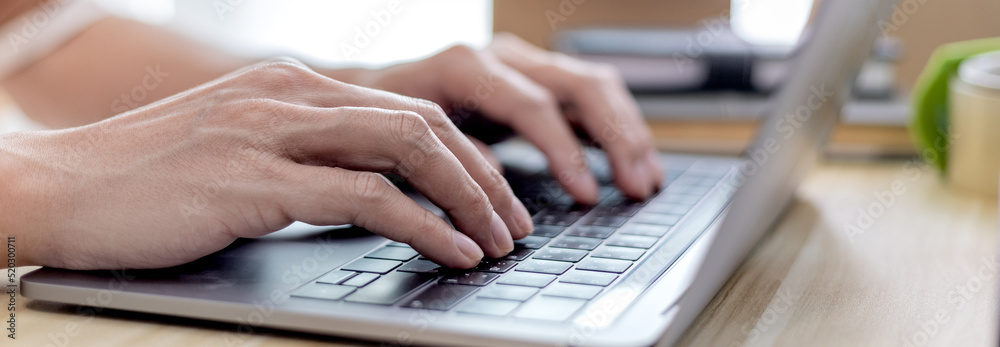 Young man uses a laptop to chat with customers who come to order product, Freelance work at home, Packaging on background, Sell online, Small business owner, Online shopping SME entrepreneur. Young man uses a laptop to chat with customers who come to order product, Freelance work at home, Packaging on background, Sell online, Small business owner, Online shopping SME entrepreneur.
