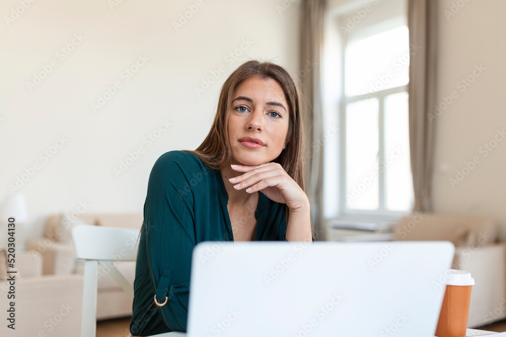 Business woman analyzing data using computer while spending time in the office. Beautiful young grinning professional woman in office. Graphs and charts Business woman analyzing data using computer while spending time in the office. Beautiful young grinning professional woman in office. Graphs and charts