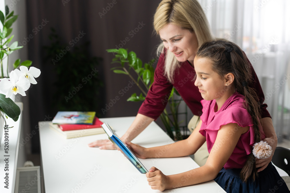 Learning and education concept. Mother and daughter schooling together. Cute pupil and his mother learning. family photo of little daughter and mom. Back to school. Family day. Education. September 1 Learning and education concept. Mother and daughter schooling together. Cute pupil and his mother learning. family photo of little daughter and mom. Back to school. Family day. Education. September 1