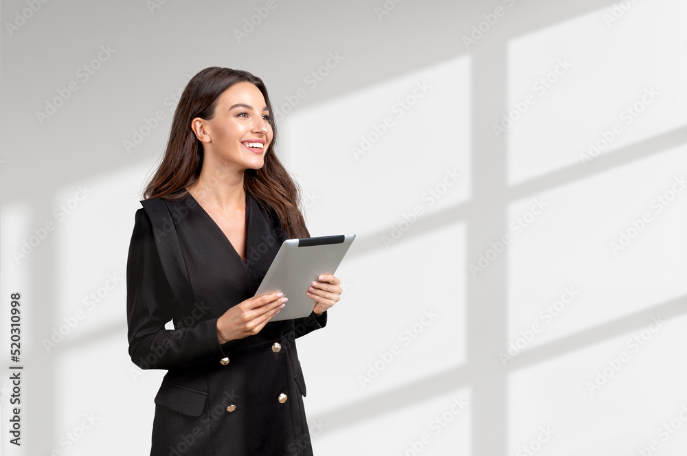 Attractive businesswoman wearing formal wear is standing holding Attractive businesswoman wearing formal wear is standing holding