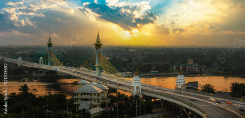Sunset over Maha Chesadabodindranusorn Bridge (Ninthaburi bridge) in the evening. The bridge over the Chao Phraya river in Nonthaburi, Thailand.