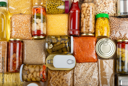 Photos Emergency survival groceries on kitchen table closeup flat lay