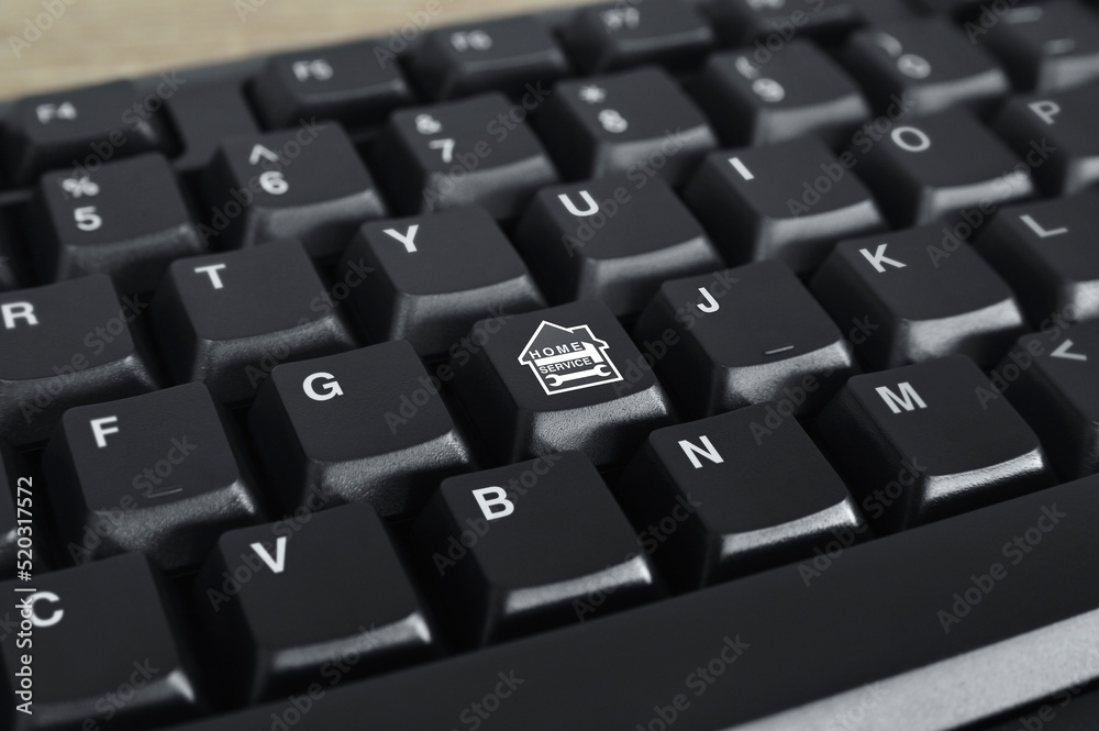 Hammer and wrench with house flat icon on black computer keyboard button, Business home service online concept Hammer and wrench with house flat icon on black computer keyboard button, Business home service online concept