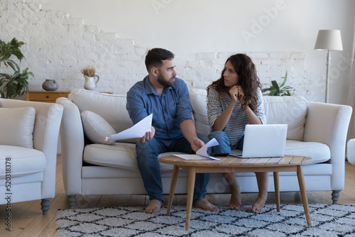 Annoyed worried married couple of homeowners, renters arguing about financial problems, discussing expenses, insurance, mortgage, rental fees, bankruptcy, eviction, overspent budget