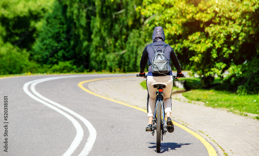 Cyclist ride on the bike path in the city Park
