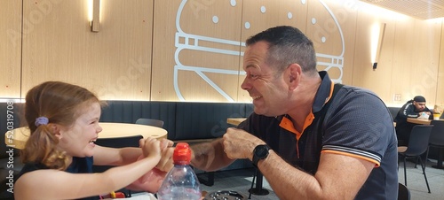 Dad and daughter at McDonalds restaurant earing and having fun photo