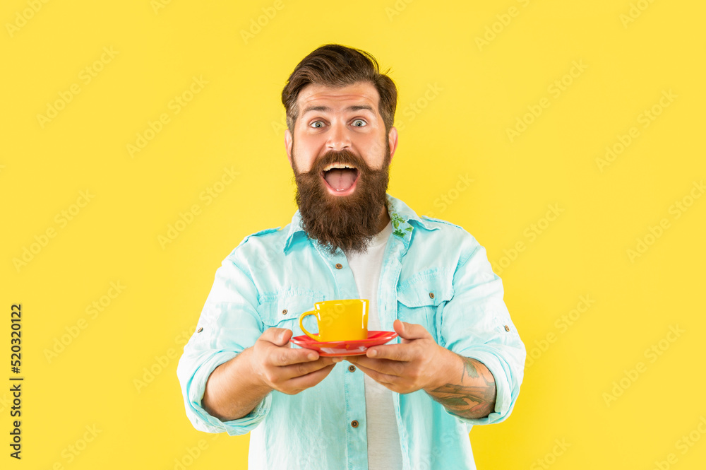 surprised bearded man drink morning coffee on yellow background, cappuccino surprised bearded man drink morning coffee on yellow background, cappuccino