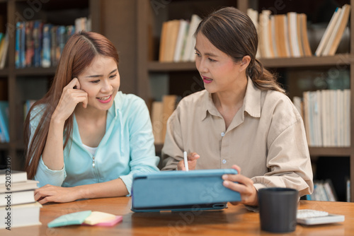 Education concept, Female tutor pointing math quiz on tablet and explaining math lesson to students