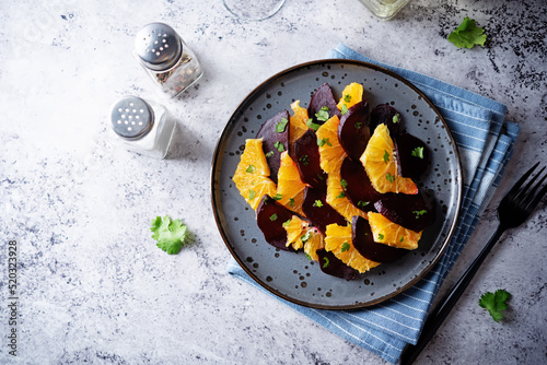 Beet orange cilantro salad with spicy olive oil vinegar sauce in a plate