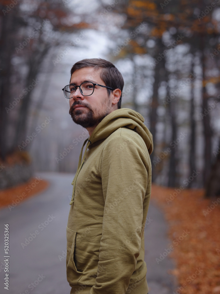 Young handsome man posing in autumn forest. Young handsome man posing in autumn forest.