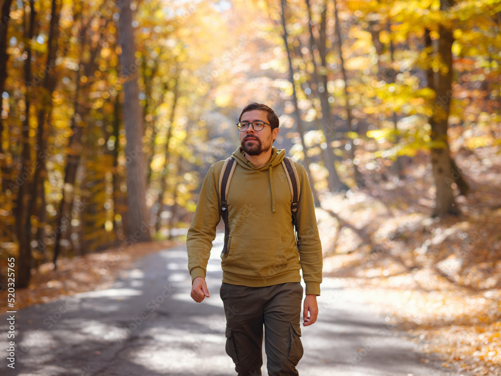 Young handsome man posing in autumn forest. Young handsome man posing in autumn forest.