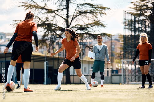 Female soccer players in action on football pitch. © Drazen
