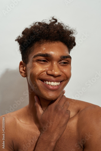Portrait of guy with golden mask on face look away
