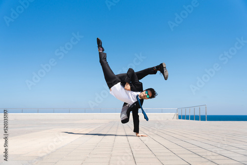 Obraz na płótnie Flexible and cool businessman doing acrobatic trick