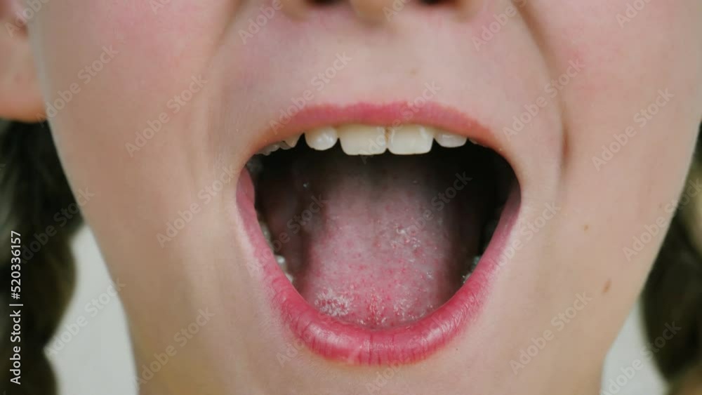 the singing mouth of a beautiful girl. Close-up of baby lips and teeth the singing mouth of a beautiful girl. Close-up of baby lips and teeth