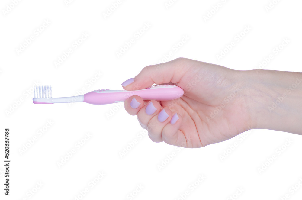 Children's pink toothbrush in hand on white background isolation Children's pink toothbrush in hand on white background isolation