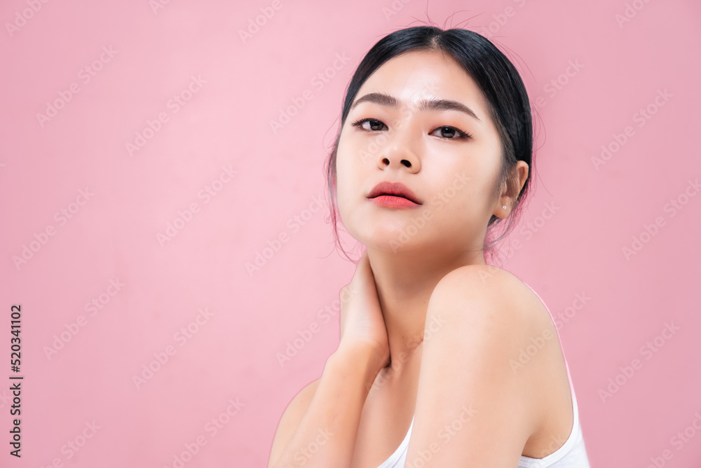 Beautiful Asian girl looking at camera isolated on pink background Beautiful Asian girl looking at camera isolated on pink background