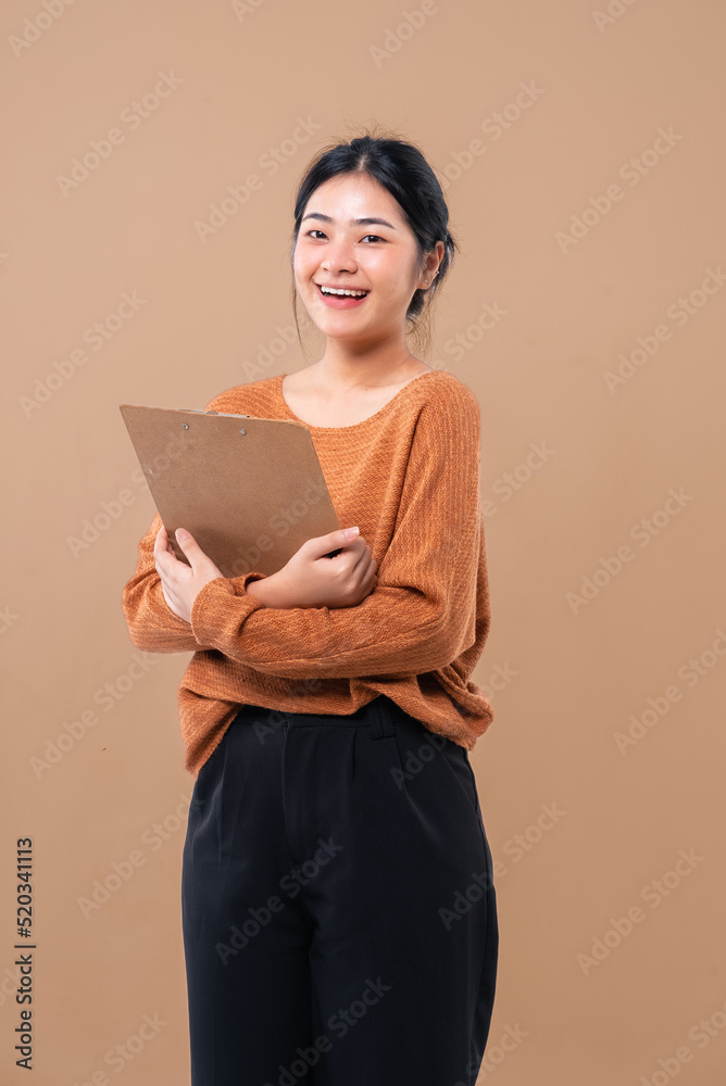 Happy Asian woman holding package parcel box isolated on background. Delivery courier and shipping Happy Asian woman holding package parcel box isolated on background. Delivery courier and shipping