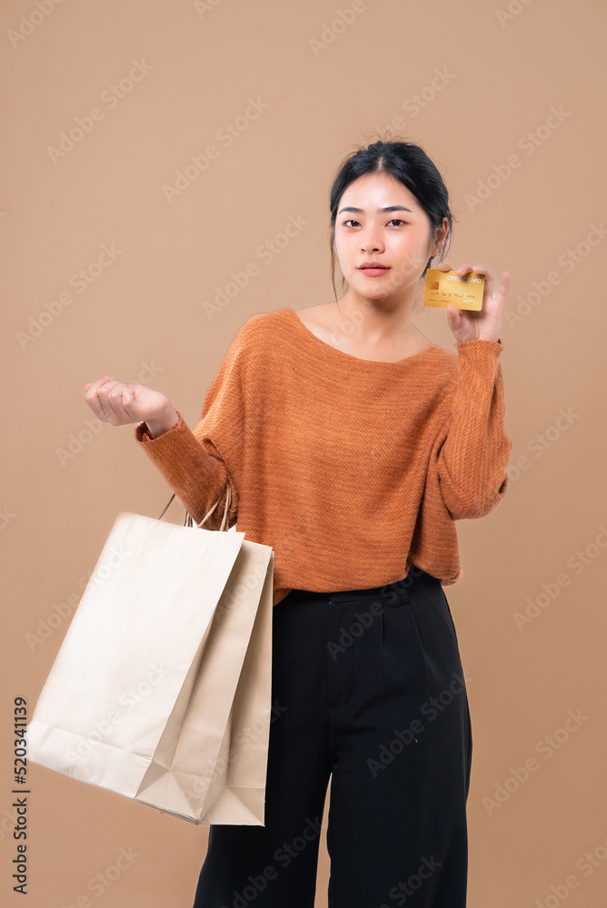 Happy Asian woman holding package parcel boxs isolated on background. Delivery courier and shippi Happy Asian woman holding package parcel boxs isolated on background. Delivery courier and shippi
