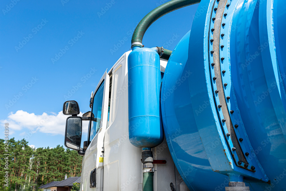 A truck with a large tank for pumping out a septic tank with a capacity of more than 20 cubic meters, visible fill indicator and overflow valve. A truck with a large tank for pumping out a septic tank with a capacity of more than 20 cubic meters, visible fill indicator and overflow valve.