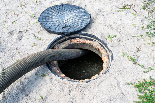 A four-inch suction pipe inserted into a home septic tank, suction of household wastewater. photo