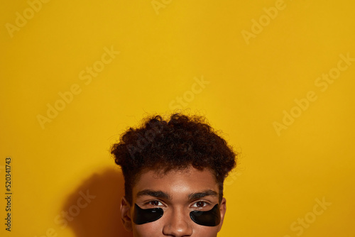 Obscure face of black guy with under eye patches