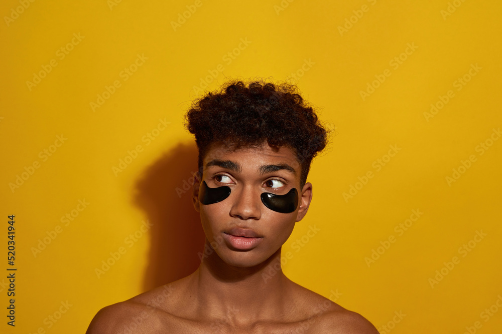 Cropped of concentrated guy with under eye patches Cropped of concentrated guy with under eye patches