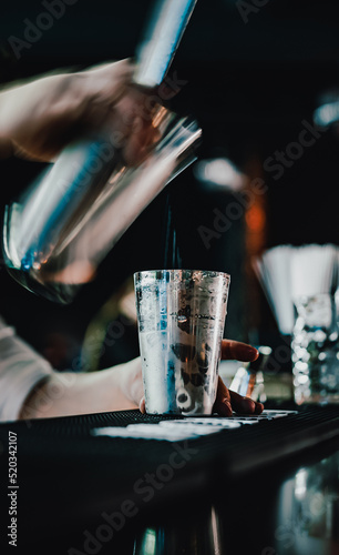 man bartender hand making cocktail in bar