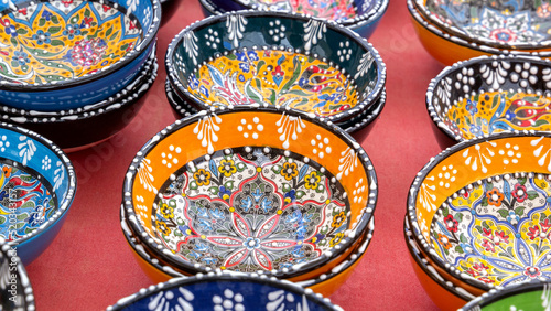 Ceramic bowls with traditional Turkish ornaments are sold at a street market. © alexey_arz