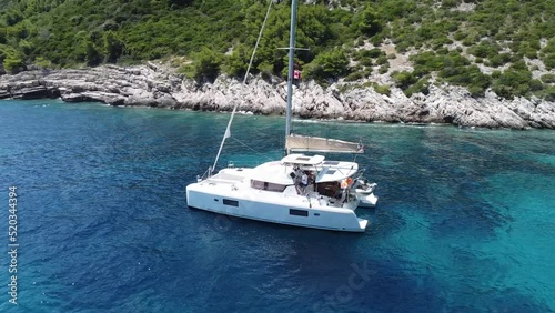 Flying around catamaran in a beautiful small bay of Croatia with final view at the sea