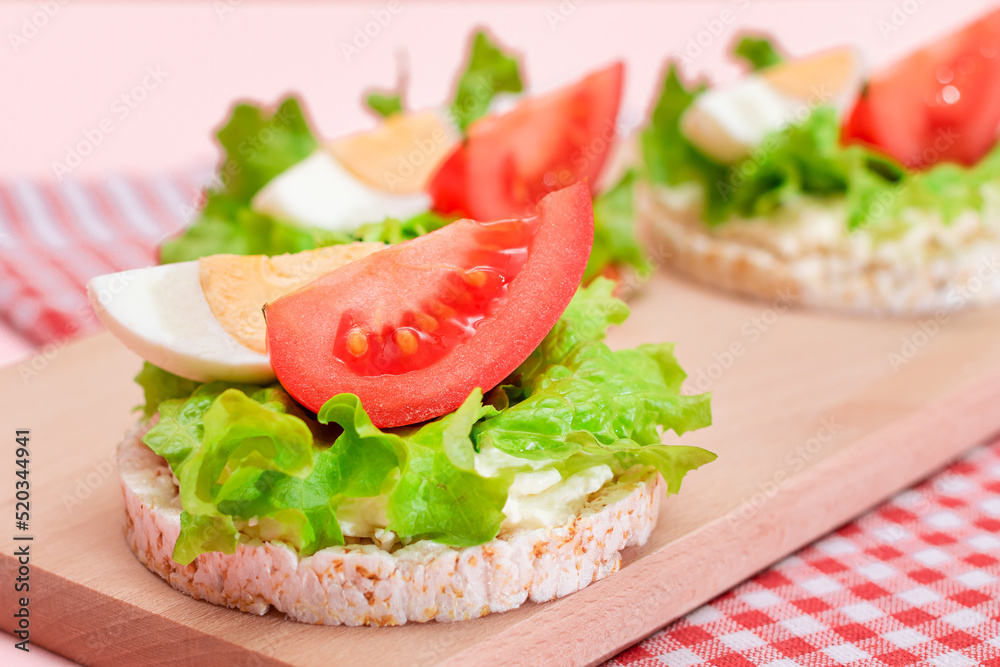 Rice Cake Sandwiches with Tomato, Lettuce and Egg on Wooden Cutting Board. Easy Breakfast. Diet Food. Quick and Healthy Sandwiches. Crispbread with Tasty Filling. Healthy Dietary Snack