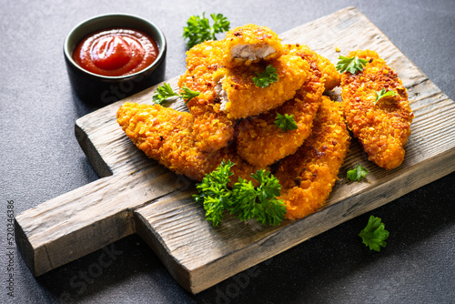 Tableau sur toile Chicken nuggets with ketchup sauce on serving board