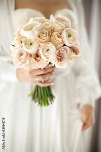 Bright wedding bouquet in hands of the bride