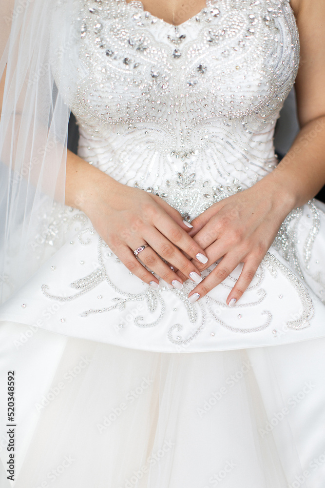 Engagement ring on bride's finger during wedding preparations Engagement ring on bride's finger during wedding preparations